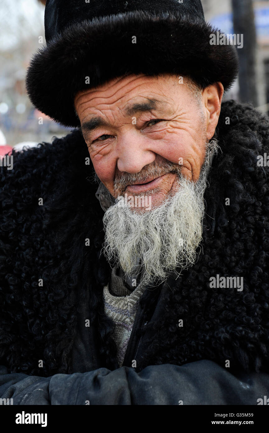 CINA provincia Xinjiang, giornata di mercato a uighur villaggio Langar vicino Kashgar, anziani con pelliccia cappello / CINA Provincia Xinjiang, Markttag in Langar einem uigurischen Dorf bei Stadt Kashgar hier lebt das Turkvolk der Uiguren, das sich zum Islam bekennt Foto Stock