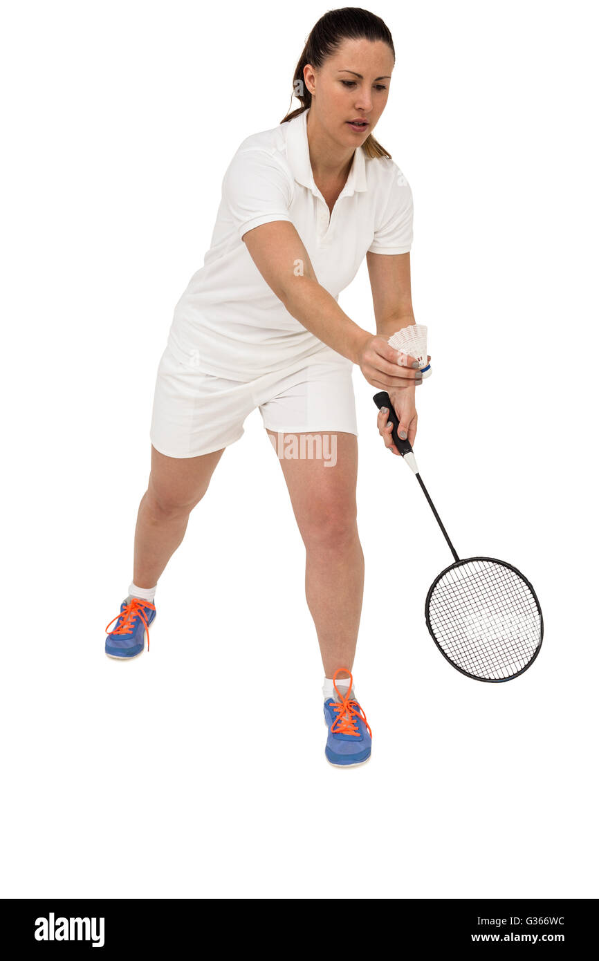 Atleta femminile tenendo un badminton racchetta pronto a servire Foto Stock