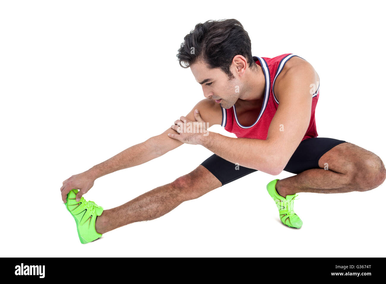 Atleta maschio che allunga la posteriori della coscia Foto Stock