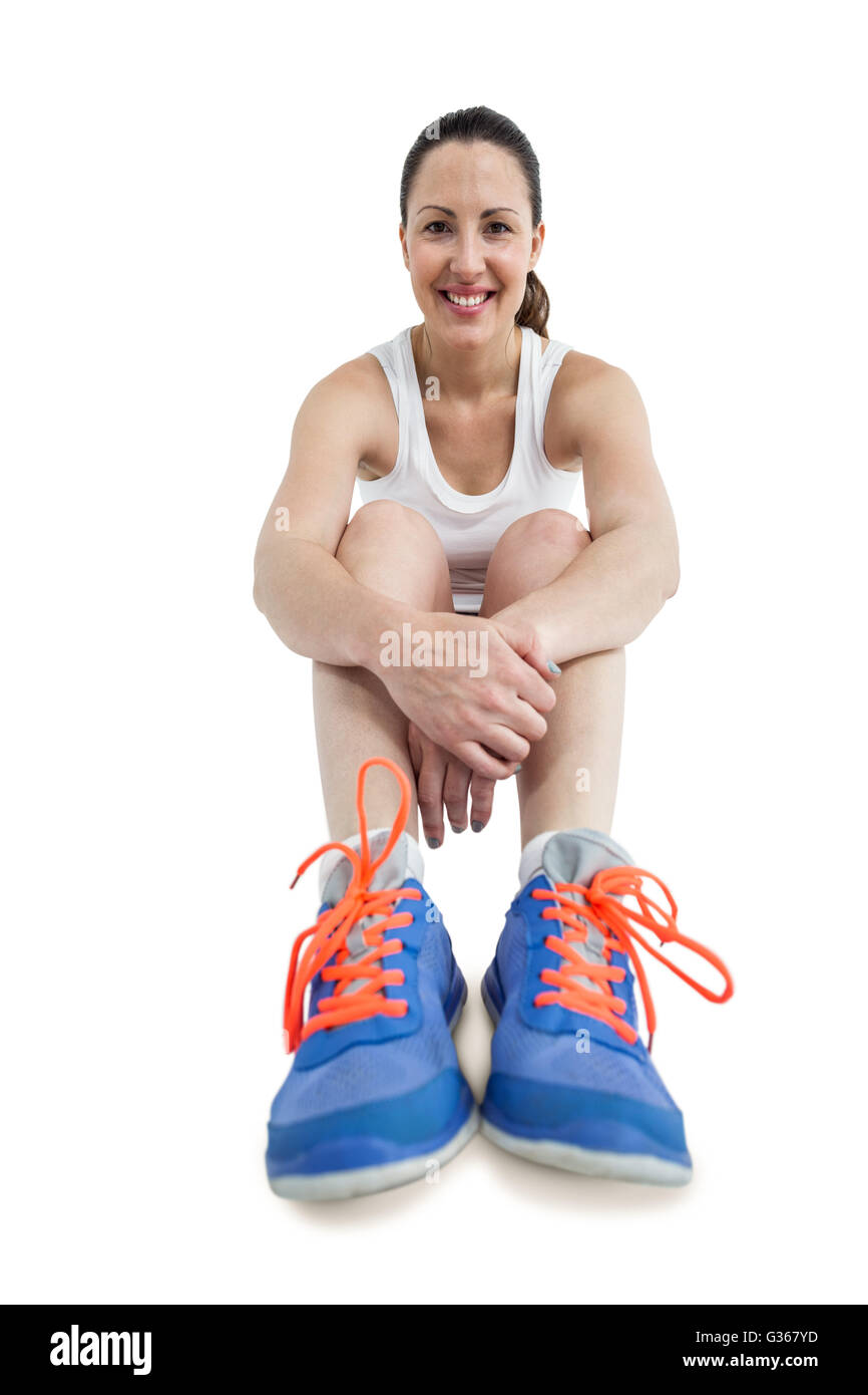 Ritratto di atleta donna seduta con calzature sportive Foto Stock