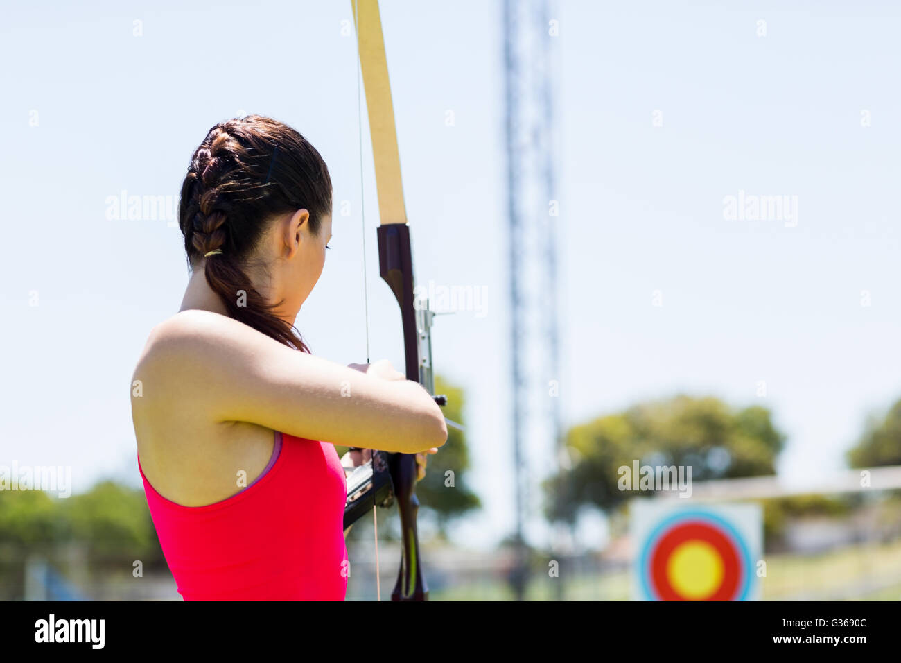 Atleta femminile praticare il tiro con l'arco Foto Stock