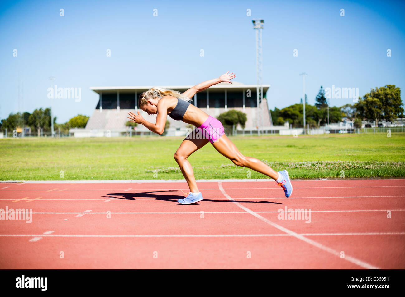 Atleta femminile in esecuzione sulla pista da corsa Foto Stock
