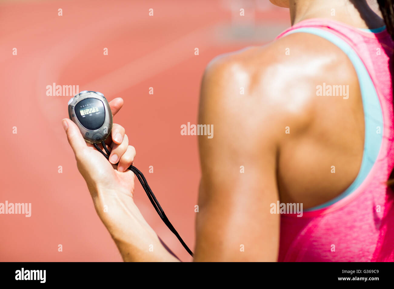 Atleta femminile utilizzando cronometro Foto Stock