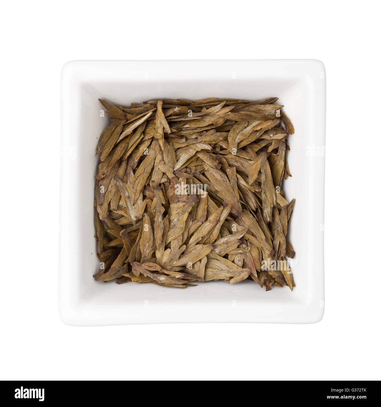 Longjing le foglie di tè in una ciotola quadrata isolati su sfondo bianco Foto Stock