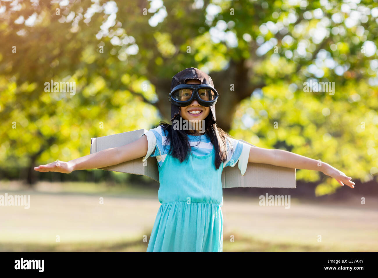 Sorridente ragazza in piedi con le braccia aperte in posizione di parcheggio Foto Stock