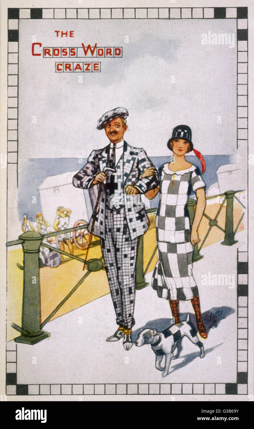 Un coraggioso giovane visualizzare la crescente "crossword craze' con i loro costumi controllati e analogamente squadrata-off piccolo cane! Data: metà 1920 Foto Stock