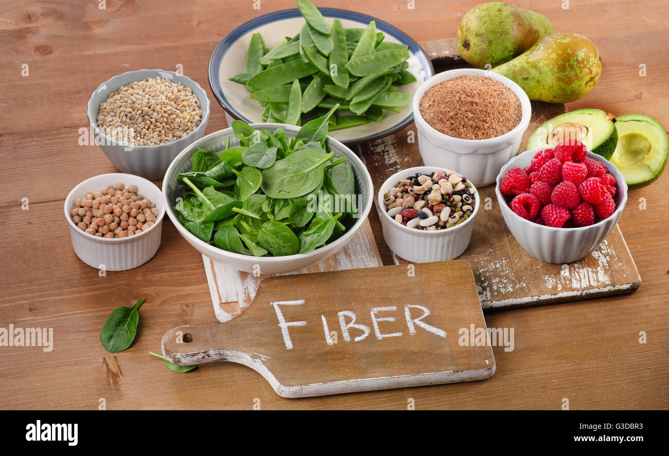 Gli alimenti ricchi di fibra su un tavolo di legno. Mangiare sano. Messa a fuoco selettiva Foto Stock