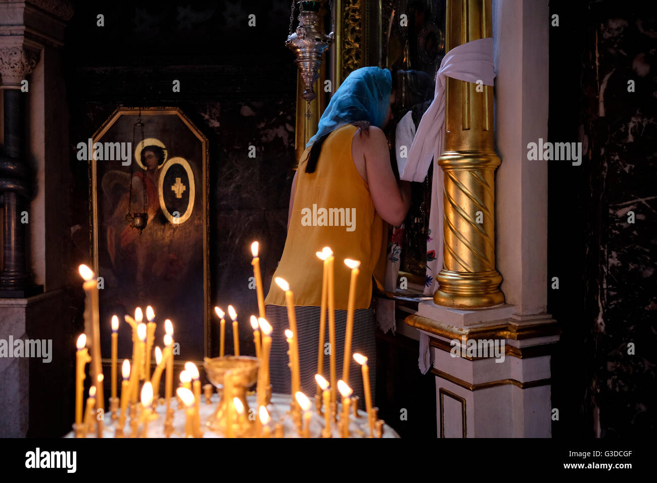 Una donna Ucraina bacia un'icona dopo un servizio di preghiera da parte della Chiesa ortodossa Ucraina del patriarcato di Kiev nella cattedrale di San Volodimir nel centro di Kiev, Ucraina Foto Stock