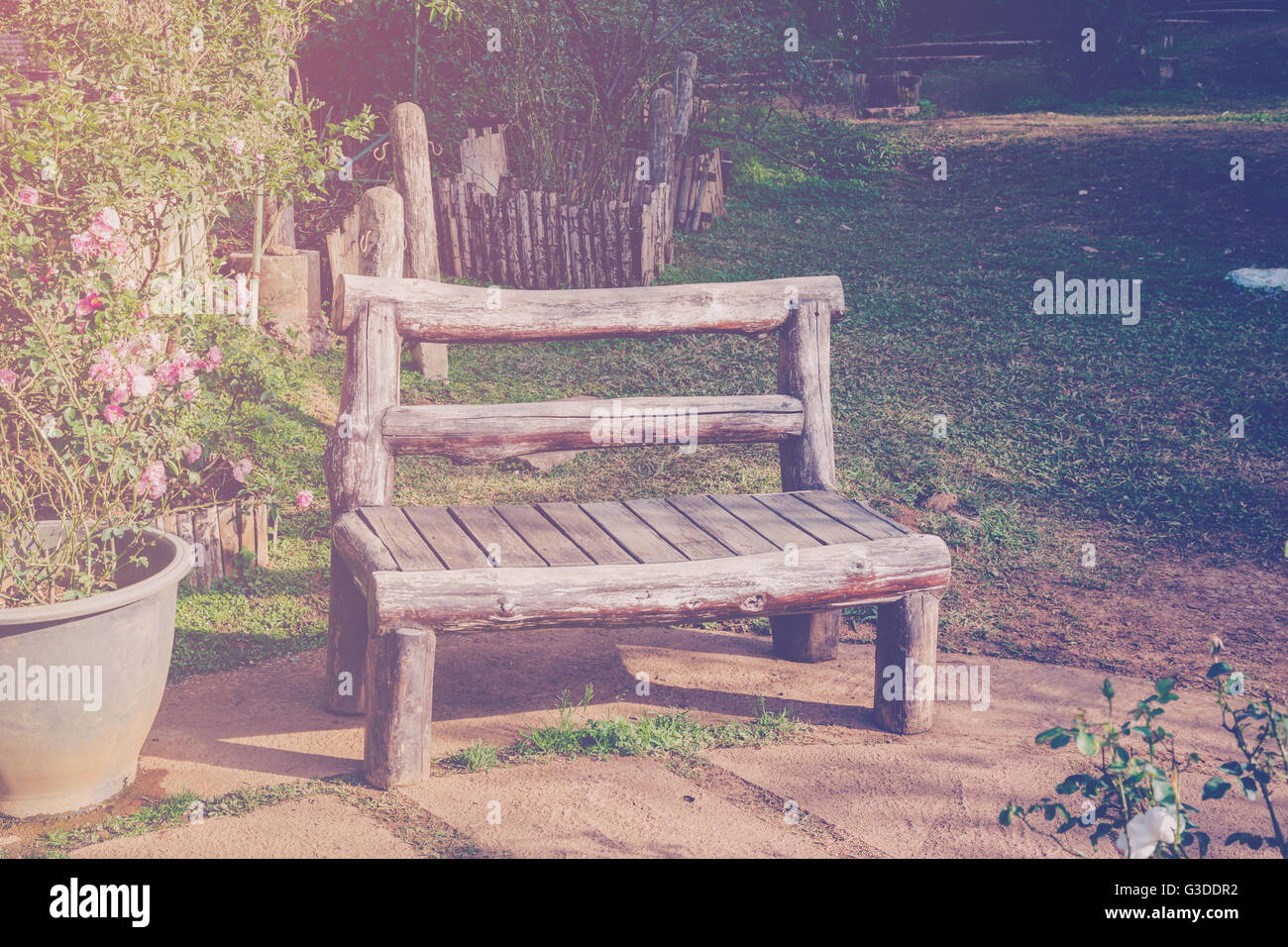 Sedia in legno in giardino e la luce del sole con tono vintage. Foto Stock