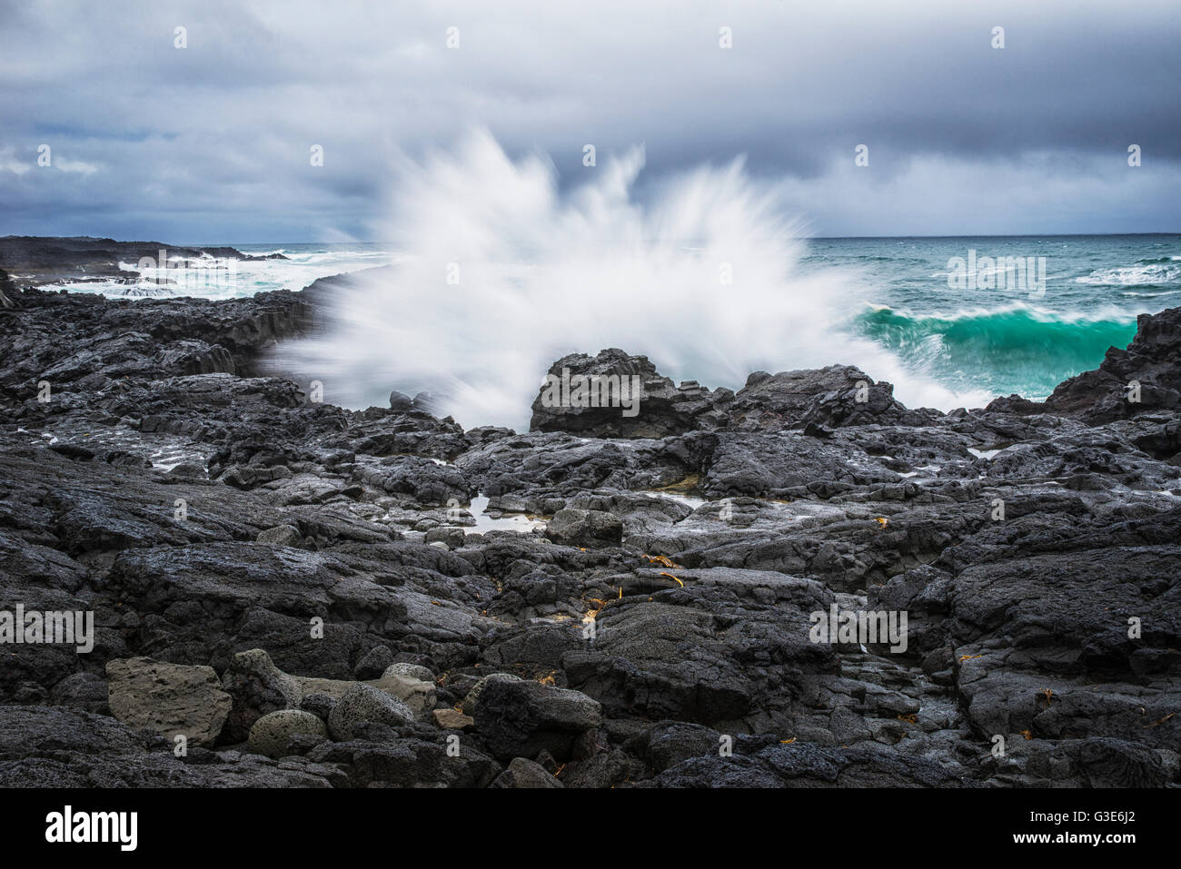 Un'onda schizzi contro le rocce in Islanda della costa meridionale; Islanda Foto Stock