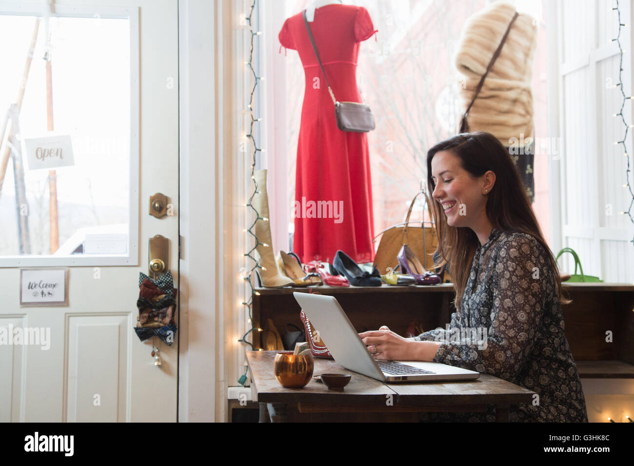 Imprenditrice lavora al computer portatile in negozio vintage Foto Stock