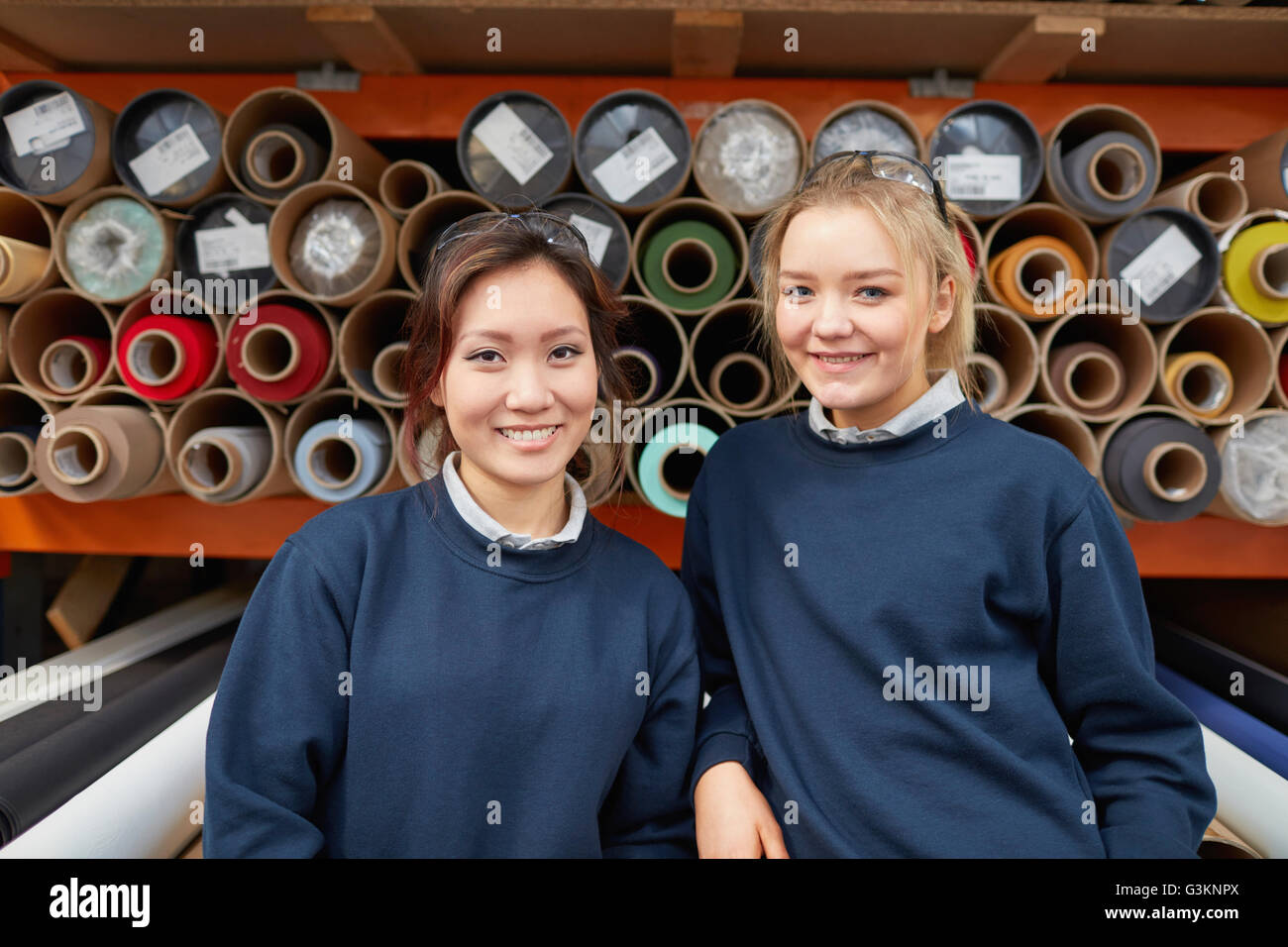 Ritratto di due donne lavoratori in fabbrica nella parte anteriore dei rulli di tessili in tenda a rullo factory Foto Stock Ritratto di due donne lavoratori in fabbrica nella parte anteriore dei rulli di tessili in tenda a rullo factory Foto Stock