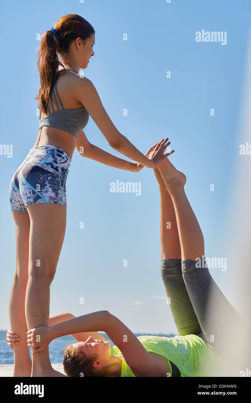 Le donne di indossare abbigliamento sportivo di tenere su ogni altro esercizio Foto Stock