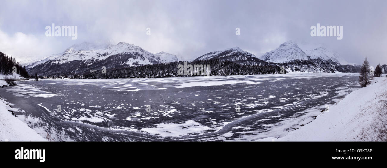 Lago ghiacciato e montagne coperte di neve, Engadina, Svizzera Foto Stock