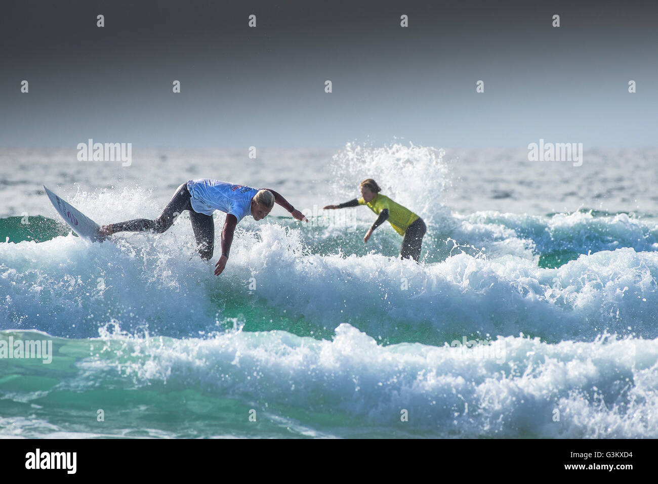 Surfers in azione spettacolare come essi partecipano in un UK Pro Surf tour di concorrenza a Fistral in Newquay, Cornwall. Regno Unito. Foto Stock