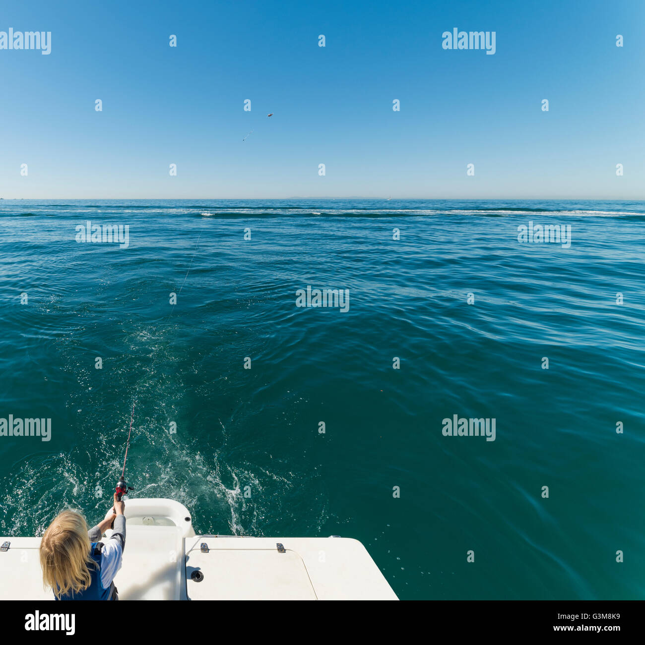 Ragazzo di pesca in barca a vela Foto Stock