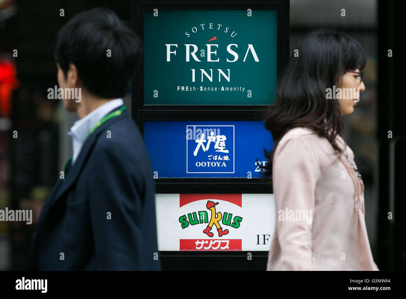 I pedoni a piedi passato un Ootoya Holdings cartello sul display al di fuori di uno dei suoi ristoranti a Shimbashi il 14 giugno 2016, Tokyo, Giappone. Ootoya Holdings è un grande ristorante giapponese catena. Dopo che il presidente e fondatore Hisami Mitsumori scomparso improvvisamente nel luglio 2015, 7 di 9 funzionari, compreso il figlio del fondatore, hanno dato a sinistra o intenzione di lasciare la società a causa di disaccordi con il nuovo presidente. © Rodrigo Reyes Marin/AFLO/Alamy Live News Foto Stock