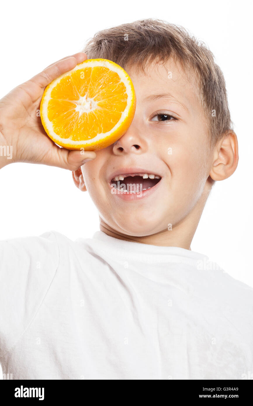 Poco carino Ragazzo con frutta di arancia doppio isolato su bianco sorridente senza denti frontali adorabili kid allegro Foto Stock