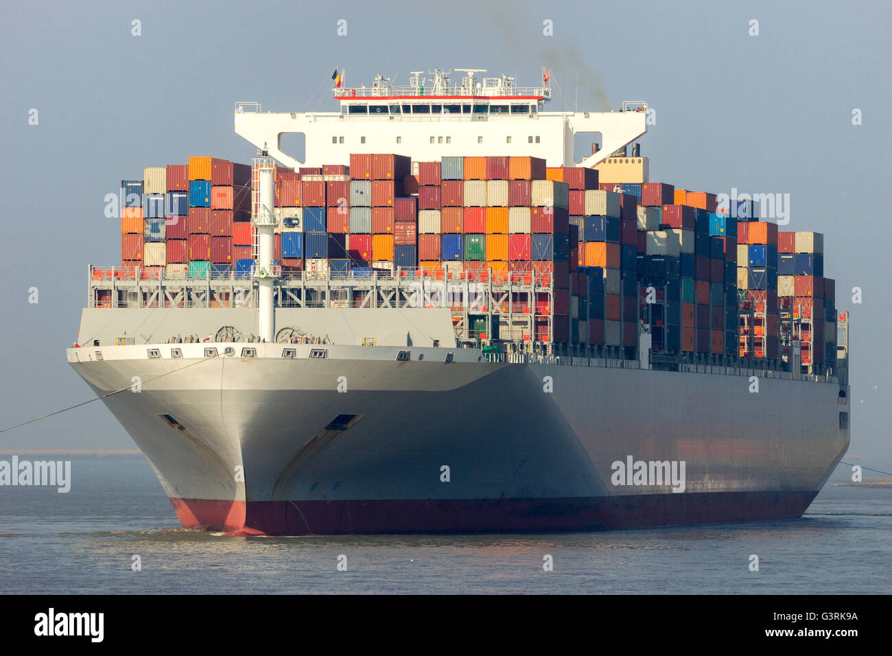 Contenitore nave lasciando un terminale per container nel porto di Anversa. Foto Stock