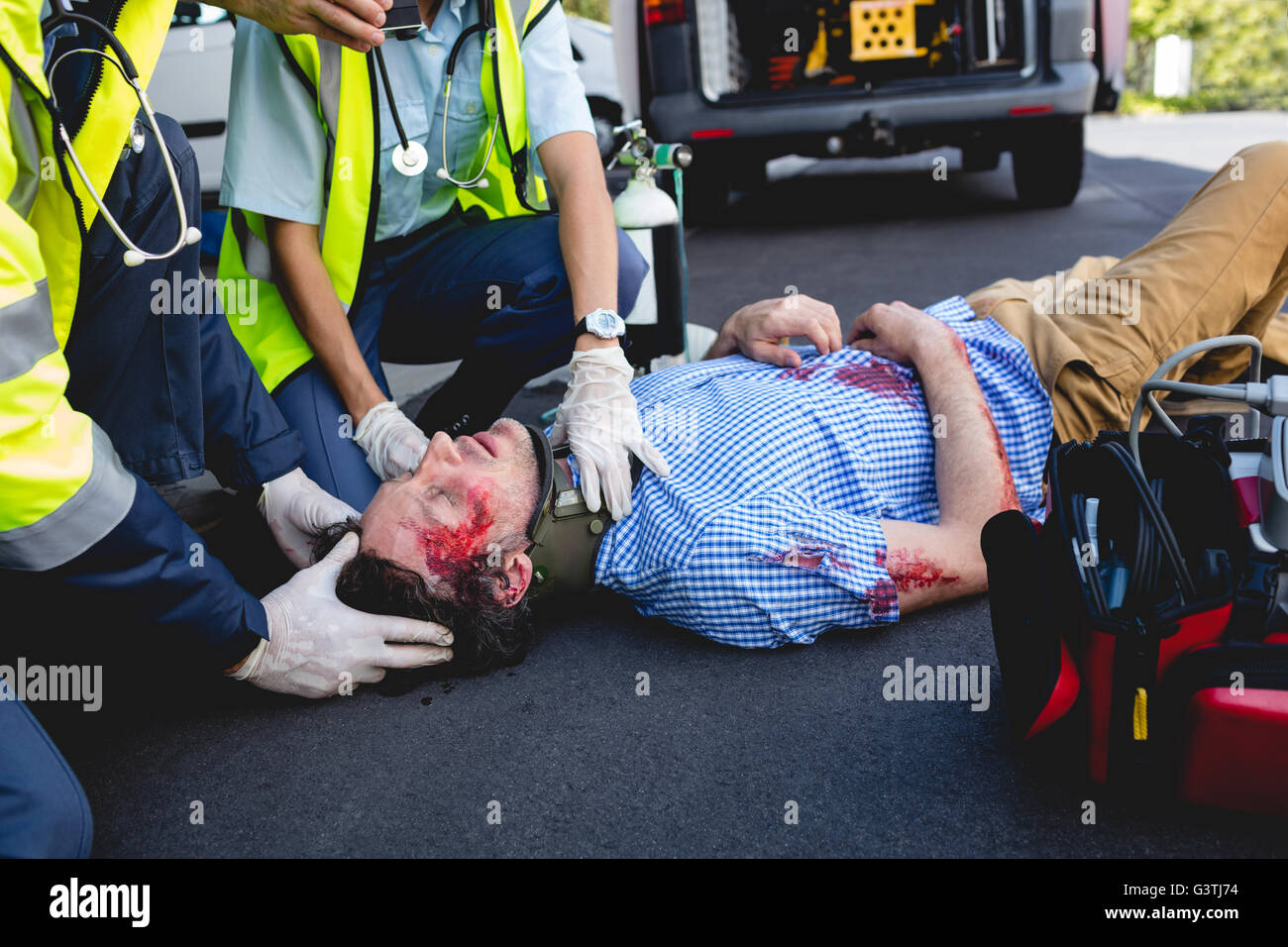 Guarigione Ambulancemen uomo ferito Foto Stock