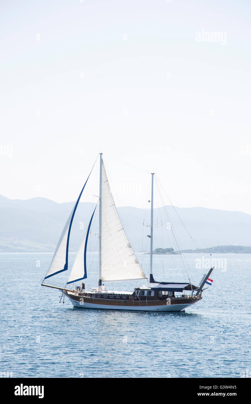 Una imbarcazione a vela vela passato Korcula bay sull isola di Korcula, Croazia Foto Stock