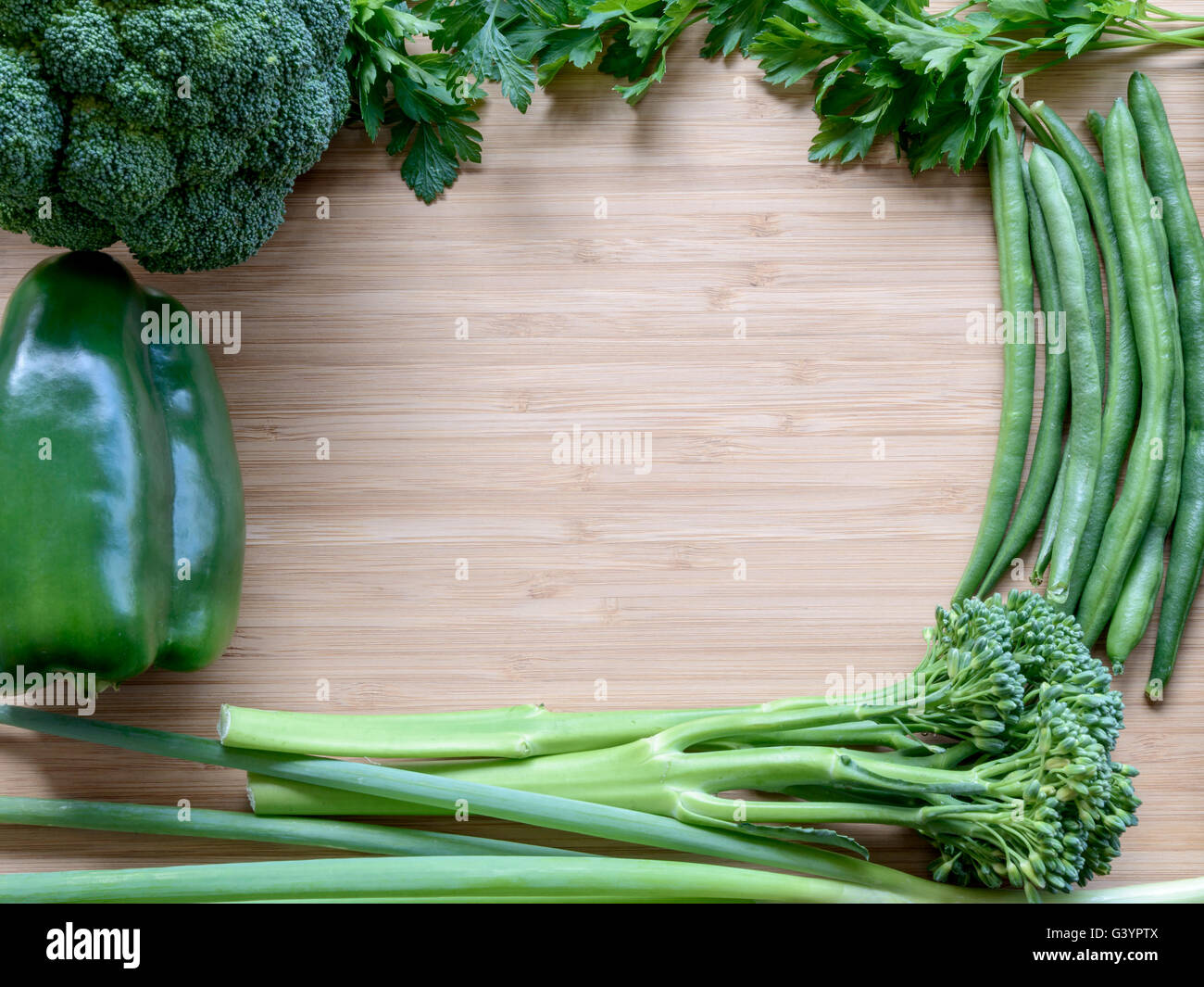 Piano superiore vista laici di fresche verdure organiche sul tagliere di legno con copyspace. Color-tonificante effetto applicato Foto Stock
