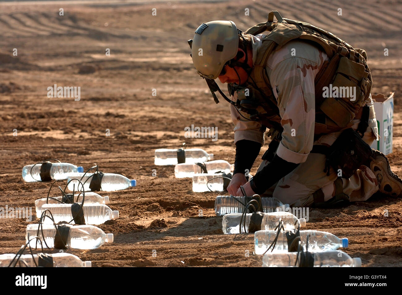 Soldier links esplosivi insieme per una prova di detonazione. Foto Stock