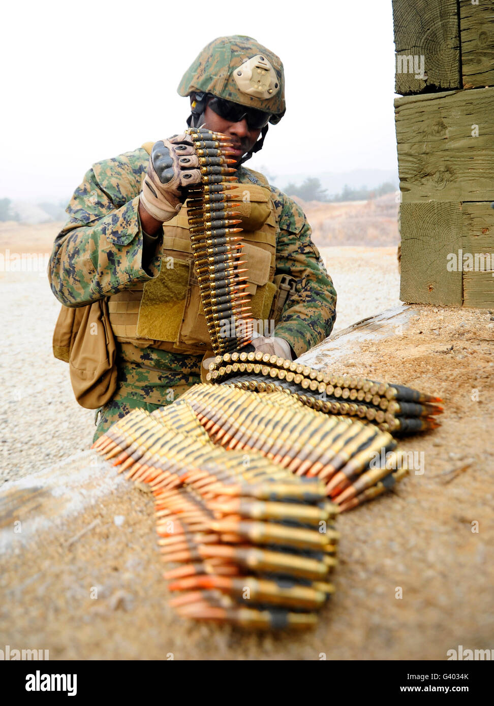 Stati Uniti Marine prepara le munizioni per un M240 mitragliatrice. Foto Stock