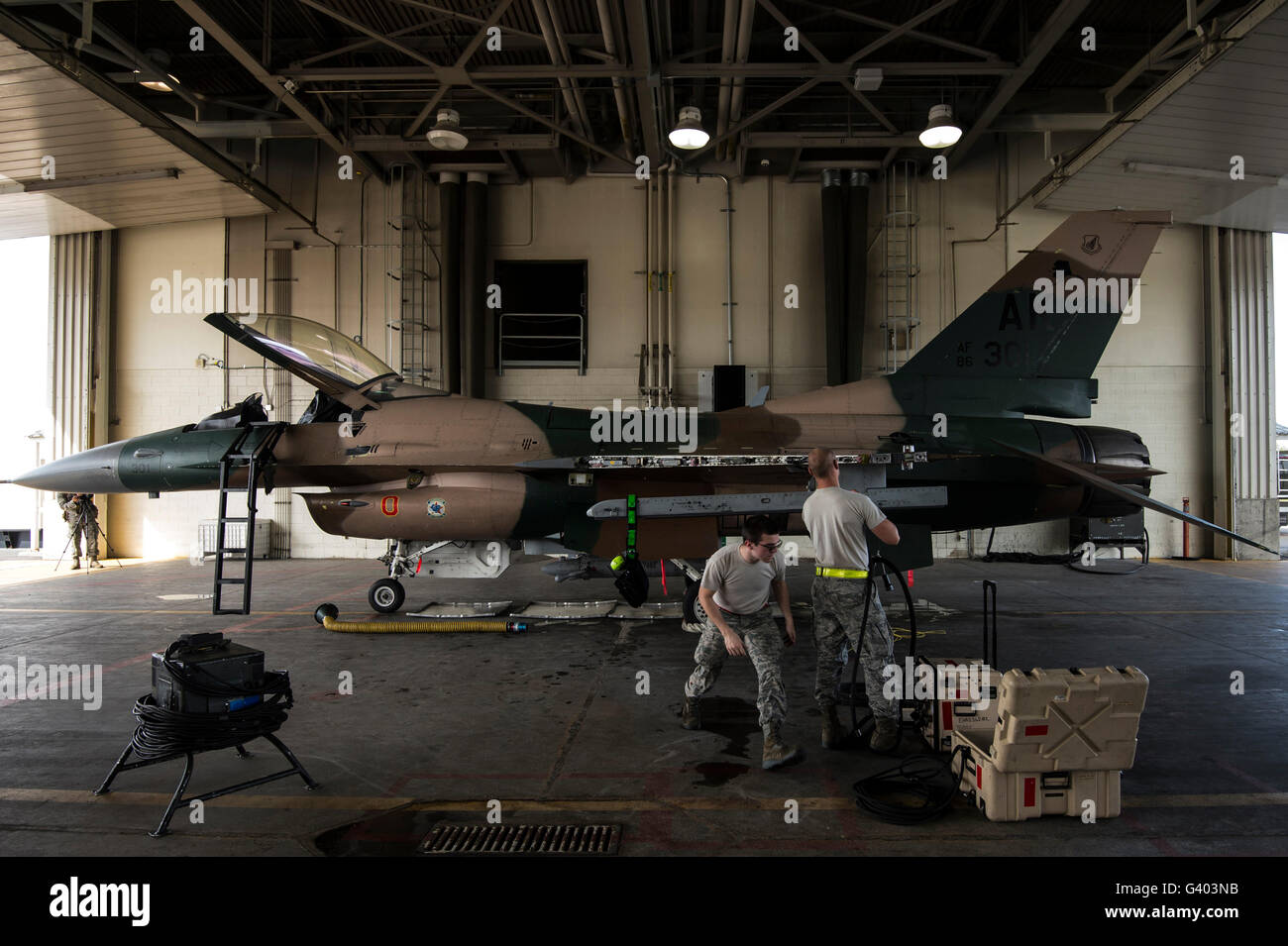 Avieri riparare i sistemi di armamenti su di un F-16C Fighting Falcon. Foto Stock