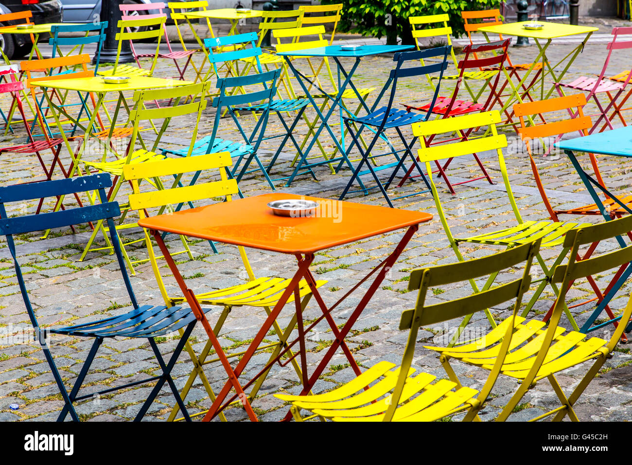 Colorati tavoli e sedie, vuoto, in una piazza di Bruxelles, Foto Stock