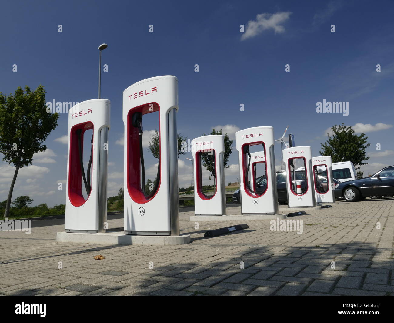 Europa Germania Tesla auto elettrica con stazione di ricarica Foto Stock