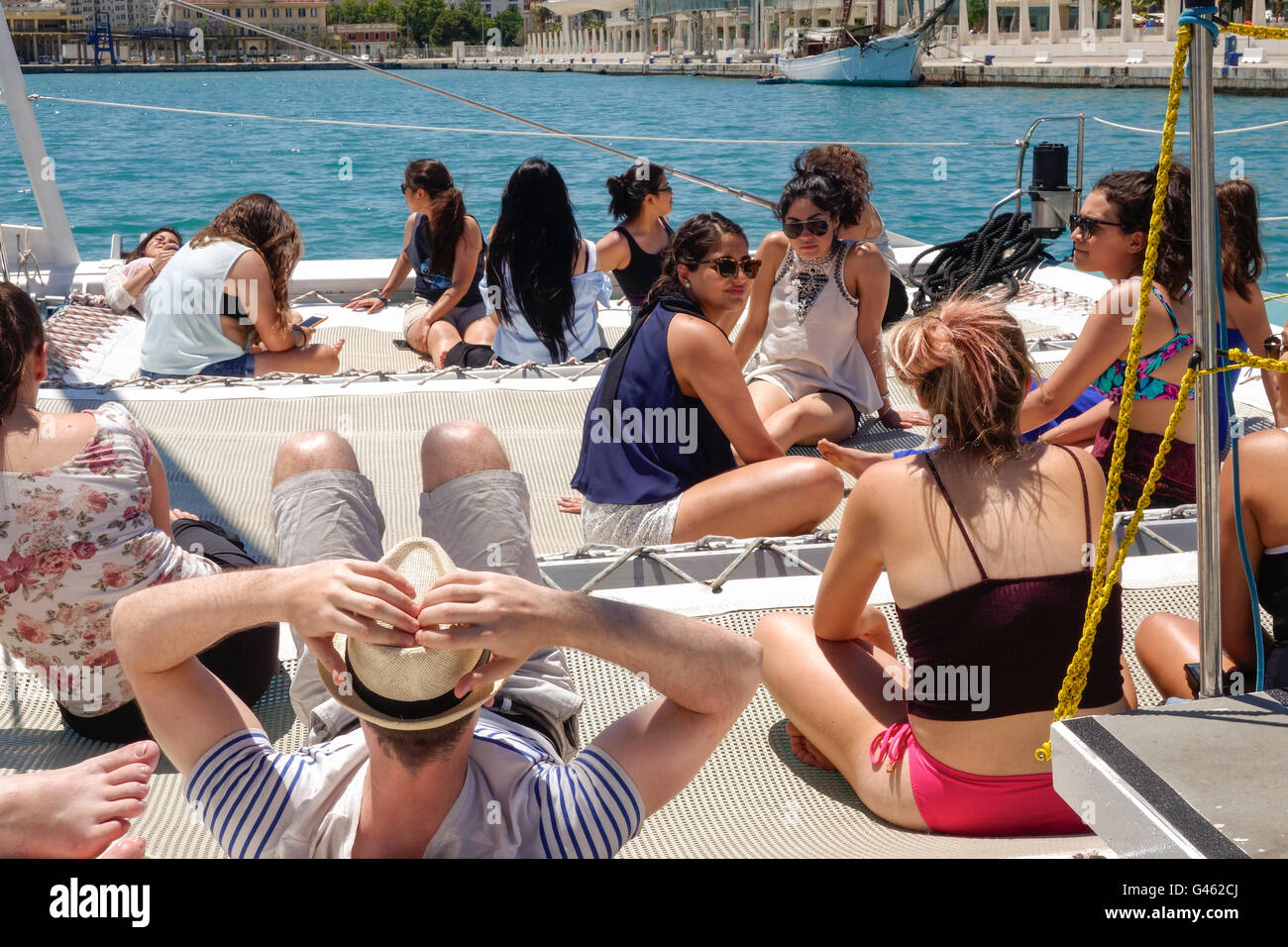Un gruppo di giovani turisti sul catamarano e barca a vela tour, rilassarsi e godersi il sole, Malaga, Andalusia, Spagna. Foto Stock