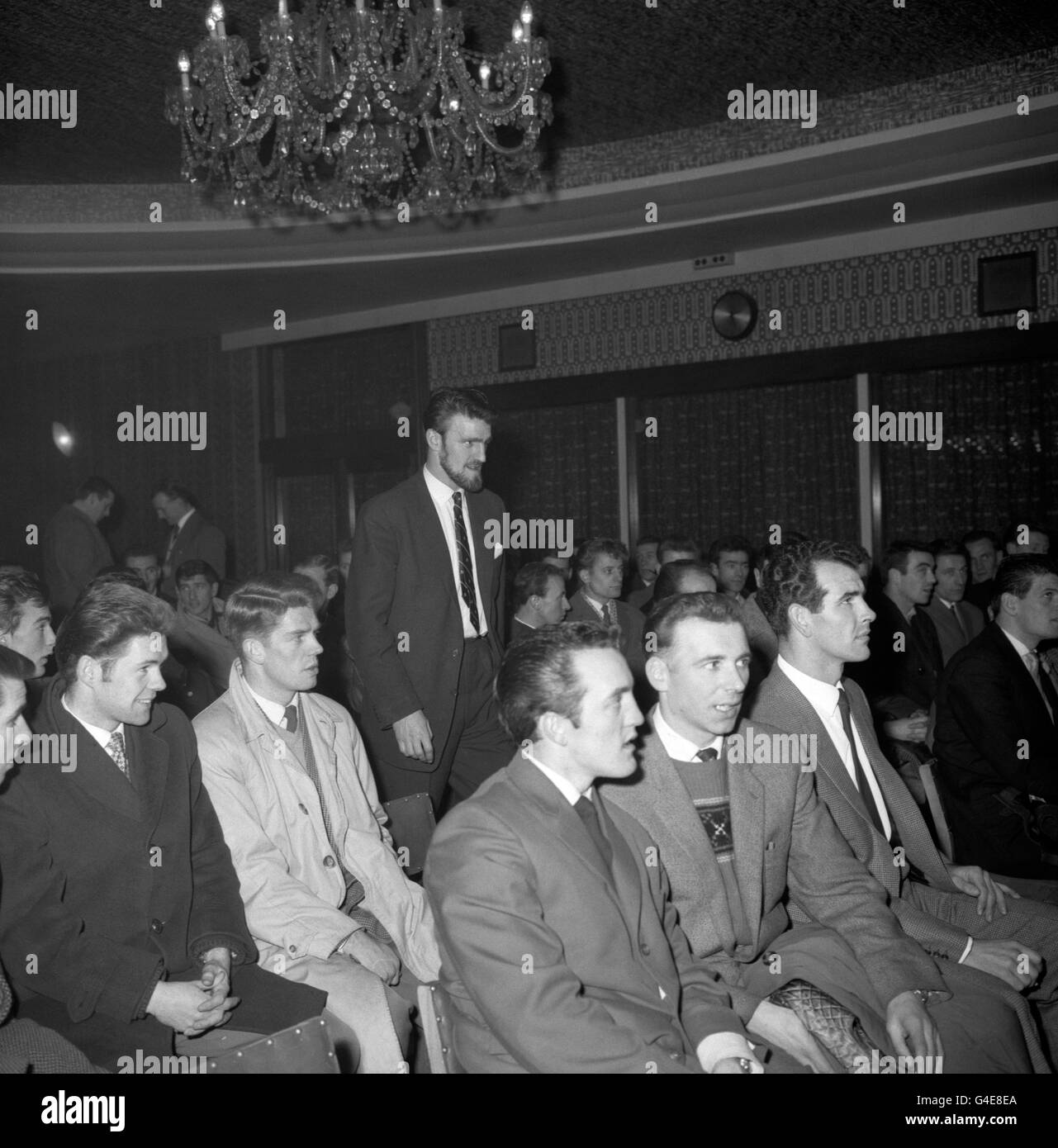 Il calciatore Fulham FC Jimmy Hill (in piedi), presidente della Professional Footballers' Association, corre attraverso il pubblico seduto, quando arriva nella sala di Manchester per l'incontro dei calciatori professionisti del Nord. L'incontro ha approvato una risoluzione simile a quella adottata dai calciatori del Sud, che chiedeva azioni di sciopero. La risoluzione è stata approvata con 254 voti contrari e sei contrari. Un'altra risoluzione approvata deplora anche gli attacchi sferrati a Jimmy Hill. Ha dichiarato che Jimmy Hill li rappresentava solo e agisce secondo le loro istruzioni, e ha aggiunto 'per suggerire che noi Foto Stock