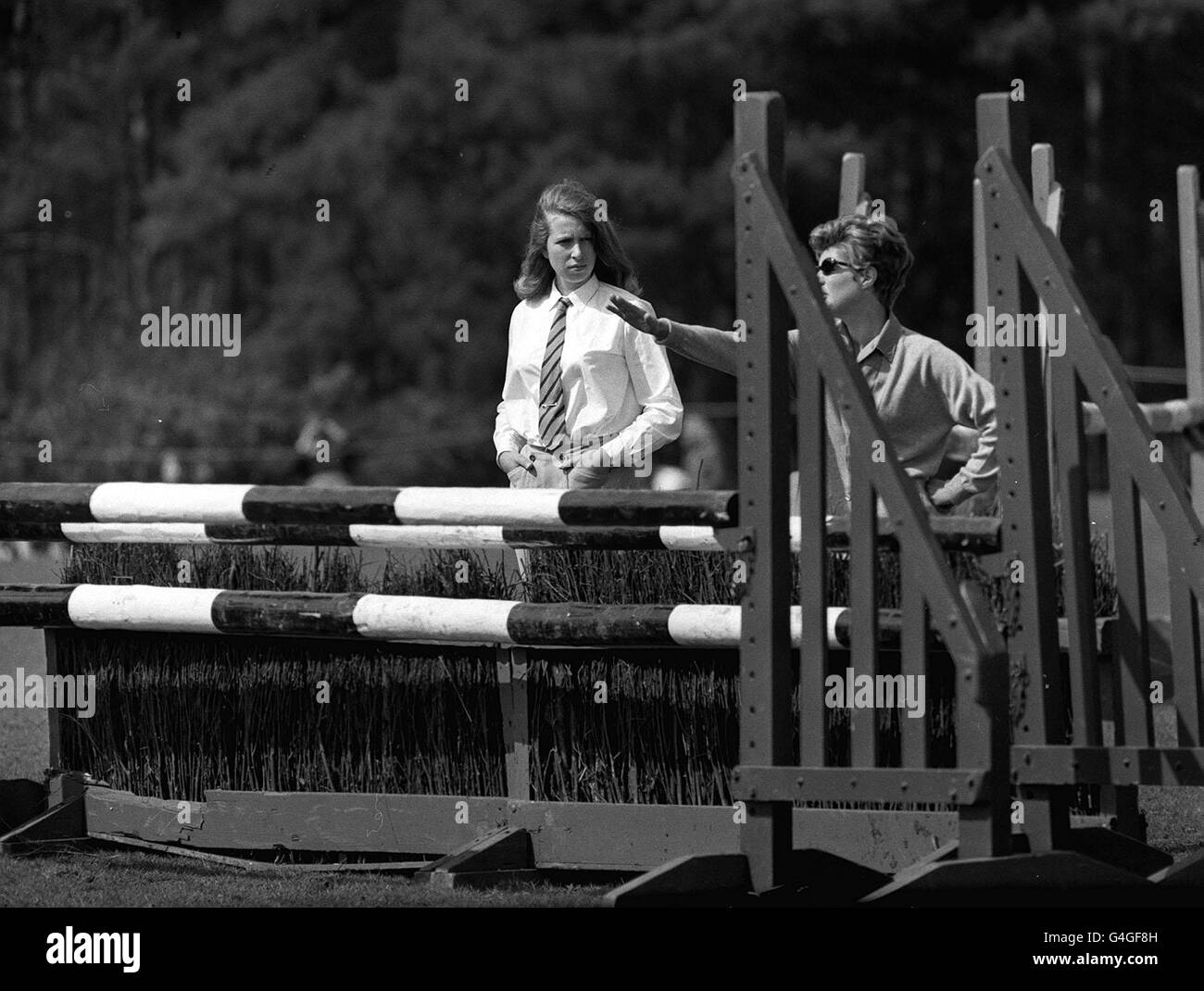PA NEWS PHOTO 26/4/68 L'EVENTO DI DRESSAGE DELLE PROVE IPPICHE DI WINDSOR AL PRATO DI SMITH, WINDSOR GREAT PARK, BERKSHIRE. PRINCIPESSA ANNE CONTROLLA GLI OSTACOLI CON UN COMPAGNO PRIMA DI PRENDERE PARTE AL SUO PONY 'STELLA VIOLA' Foto Stock