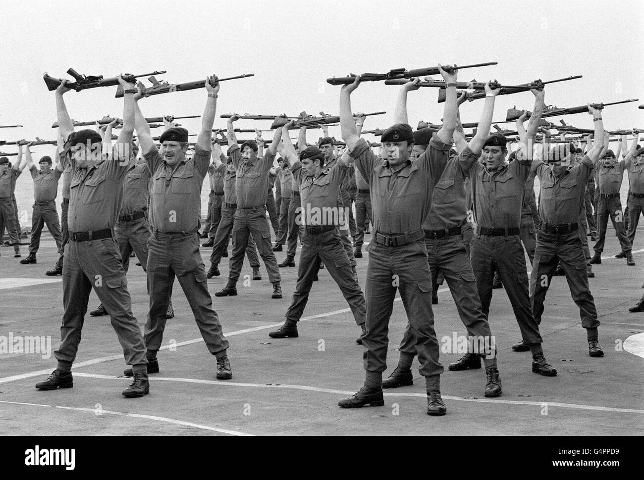 LA GUERRA DELLE FALKLANDS: Membri DI UNA compagnia : 40 Comandos marini reali, tenendo in assetto sul ponte della portante HMS Hermes mentre si dirige a sud per le Isole Falkland con la task force navale britannica. Foto Stock