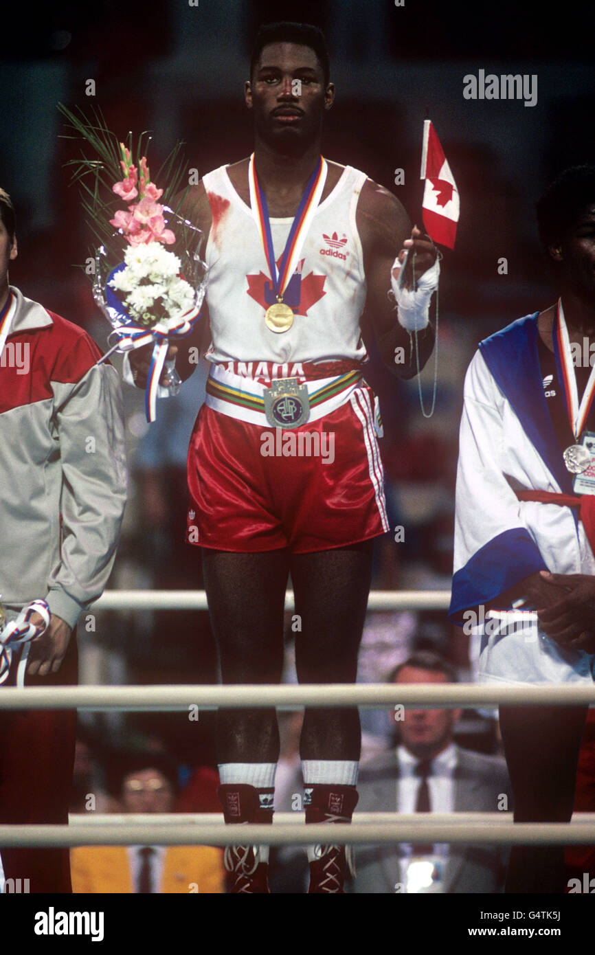 Il canadese Lennox Lewis sta per l'inno nazionale con la sua medaglia d'oro, tenendo i fiori e la bandiera del Canada. Lewis ha vinto l'oro dopo aver battuto Riddick Bowe in finale. Lennox Lewis sarebbe poi andare a rappresentare la Gran Bretagna e sarebbe diventato l'indiscusso campione di pesi massimi del mondo. Foto Stock