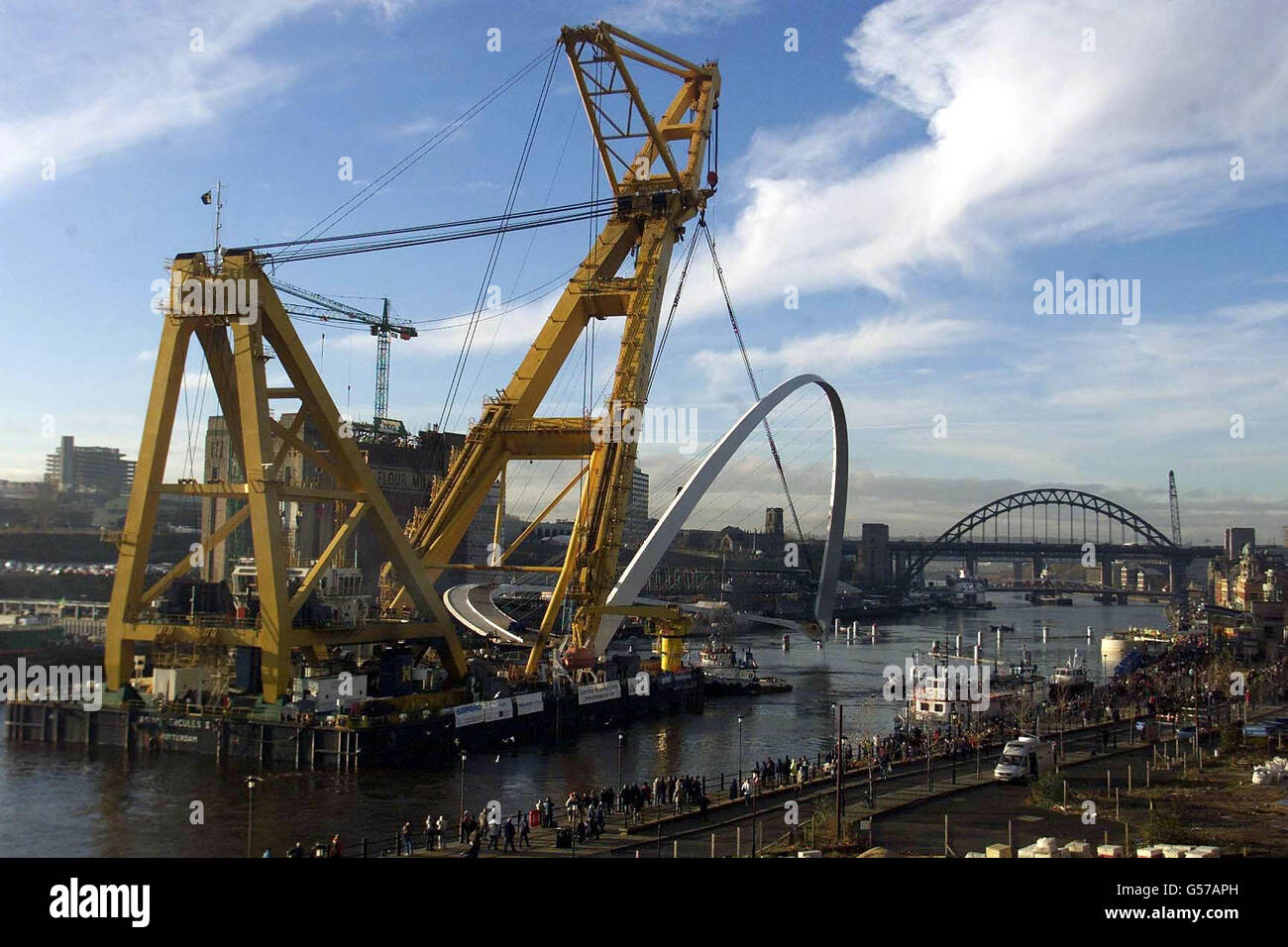 La più grande gru galleggiante del mondo Asian Hercules II, sposta il Gateshead Millennium Bridge da 850 tonnellate sul fiume Tyne, nella sua posizione permanente. Il ponte di 22 milioni di persone si estende sul fiume Tyne per creare un collegamento pedonale e ciclabile. * tra i Gateshead Quays e la vicina banchina di Newcastle. Il design della struttura ne consente la rotazione per consentire il passaggio delle barche al di sotto e il movimento del ponte è stato paragonato al lampeggio di un occhio. Foto Stock