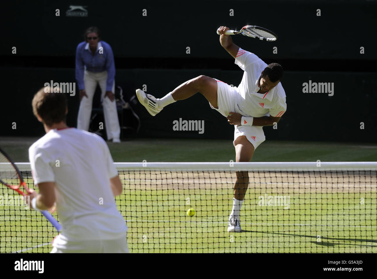Franc'es Jo-Wilfried Tsonga reagisce dopo essere stato colpito con una palla da tennis nella sua partita contro Andy Murray della Gran Bretagna durante l'undici giorno dei Campionati di Wimbledon 2012 presso l'All England Lawn Tennis Club, Wimbledon. Foto Stock