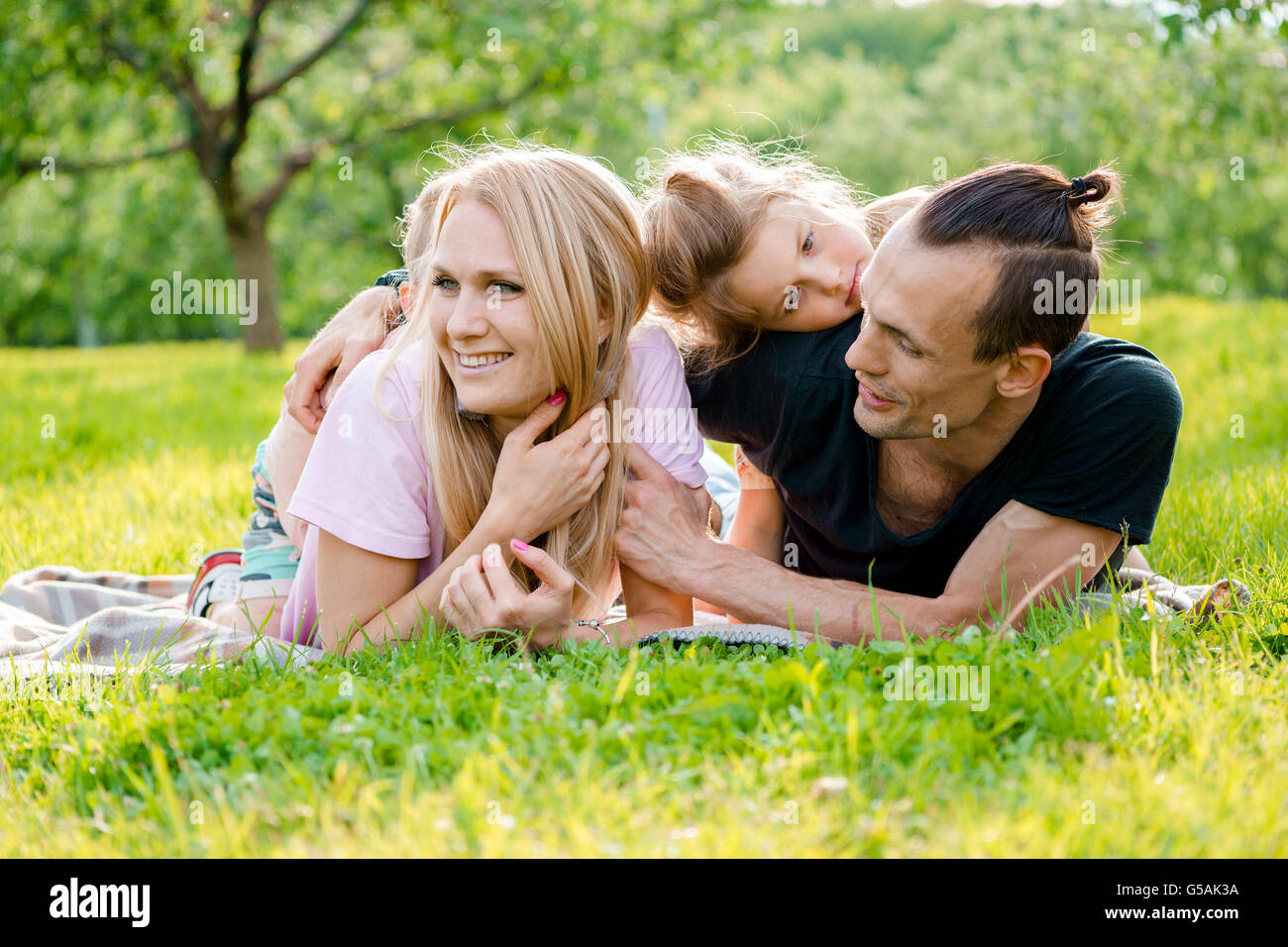 Famiglia giacente su erba in campagna Foto Stock