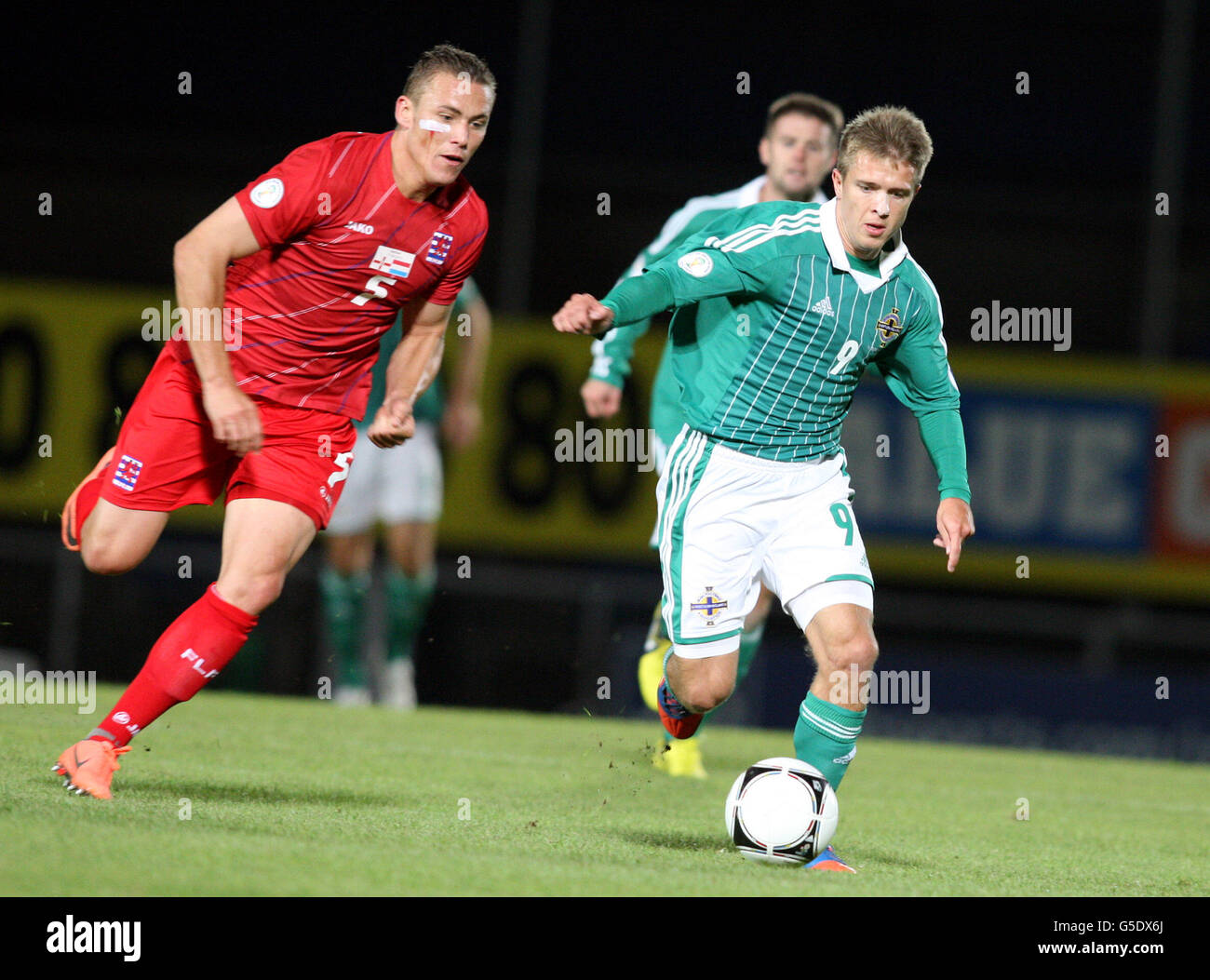 Jamie Ward dell'Irlanda del Nord in azione con Tom Schnell del Lussemburgo (a sinistra) durante la partita di qualificazione della Coppa del mondo FIFA 2014 Windsor Park, Belfast. Foto Stock