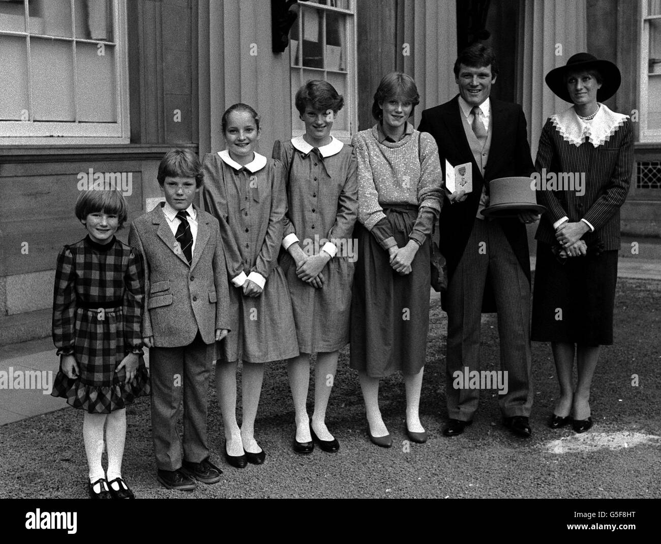 Eddie Grey, Manager del LEED United FC, che ha ricevuto l'insigne di MBE nella cerimonia di investitura fuori Buckingham Palace, Londra. Dopo la presentazione pose con la moglie Linda e la famiglia (L - R) Caterina di cinque anni: Stuart di 9 anni, Natalie 11, Kirsty 12, Fiona 13, . Foto Stock