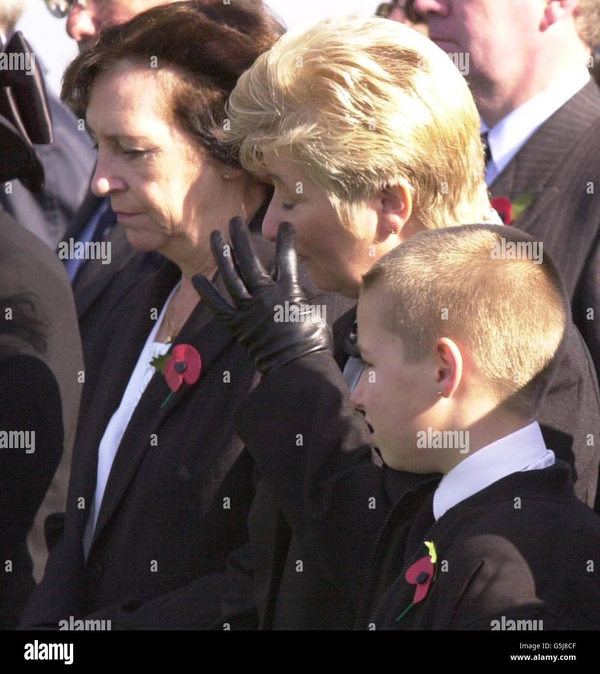 Annette Wilkinson, la bisnipote del privato Harry Wilkinson, con il suo nove anni Jay e June Brammer, strinse l'occhio durante i funerali del primo funerale del soldato della guerra mondiale al cimitero di Prowes Point, Commines-Warneton, Hainaut in Belgio. Wilkinson, 29 anni, da Bury, Lancashire del secondo battaglione Lancashire Fusiliers, è stato ucciso in azione il 10 novembre 1914, in un campo in Belgio. I suoi resti con il suo tag di identità e il suo e Lancashire Fusiliers badge cappello sono stati trovati solo 87 anni più tardi, nel gennaio 2000 in campo a Ploegsteert Wood. Foto Stock