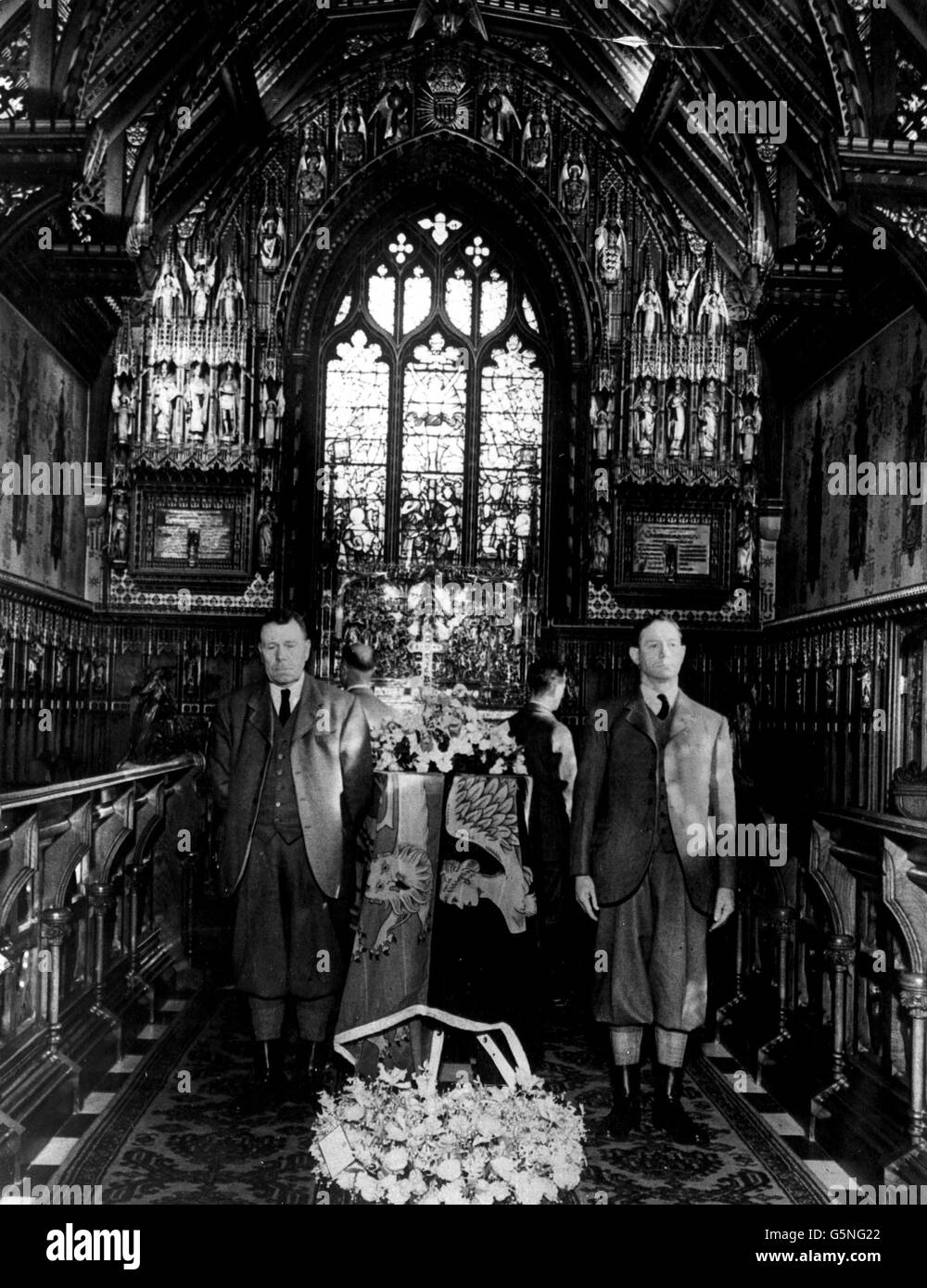 La bara di Re Giorgio VI, drappeggiato in uno Standard reale e sorvegliato da operai della tenuta di Sandringham, nella piccola Chiesa di Santa Maria Maddalena, nei terreni della Casa di Sandringham. Di fronte si trovano il custode William Clarke (a sinistra) e il custode Edward Dodds. Foto Stock