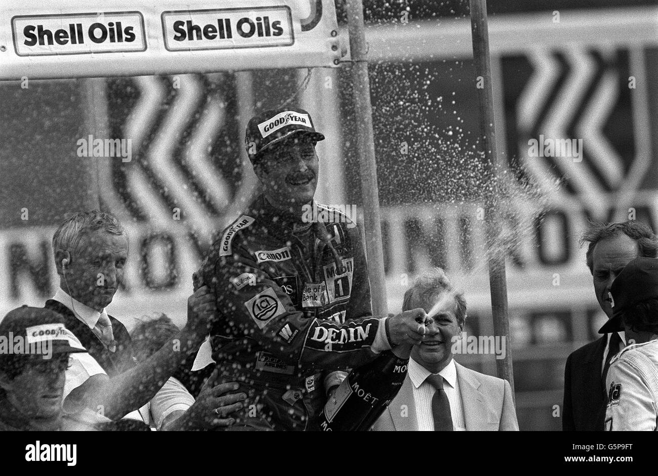 Nigel Mansell celebra la vittoria del Gran Premio di Gran Bretagna a Brands Hatch con lo champagne tradizionale. Foto Stock