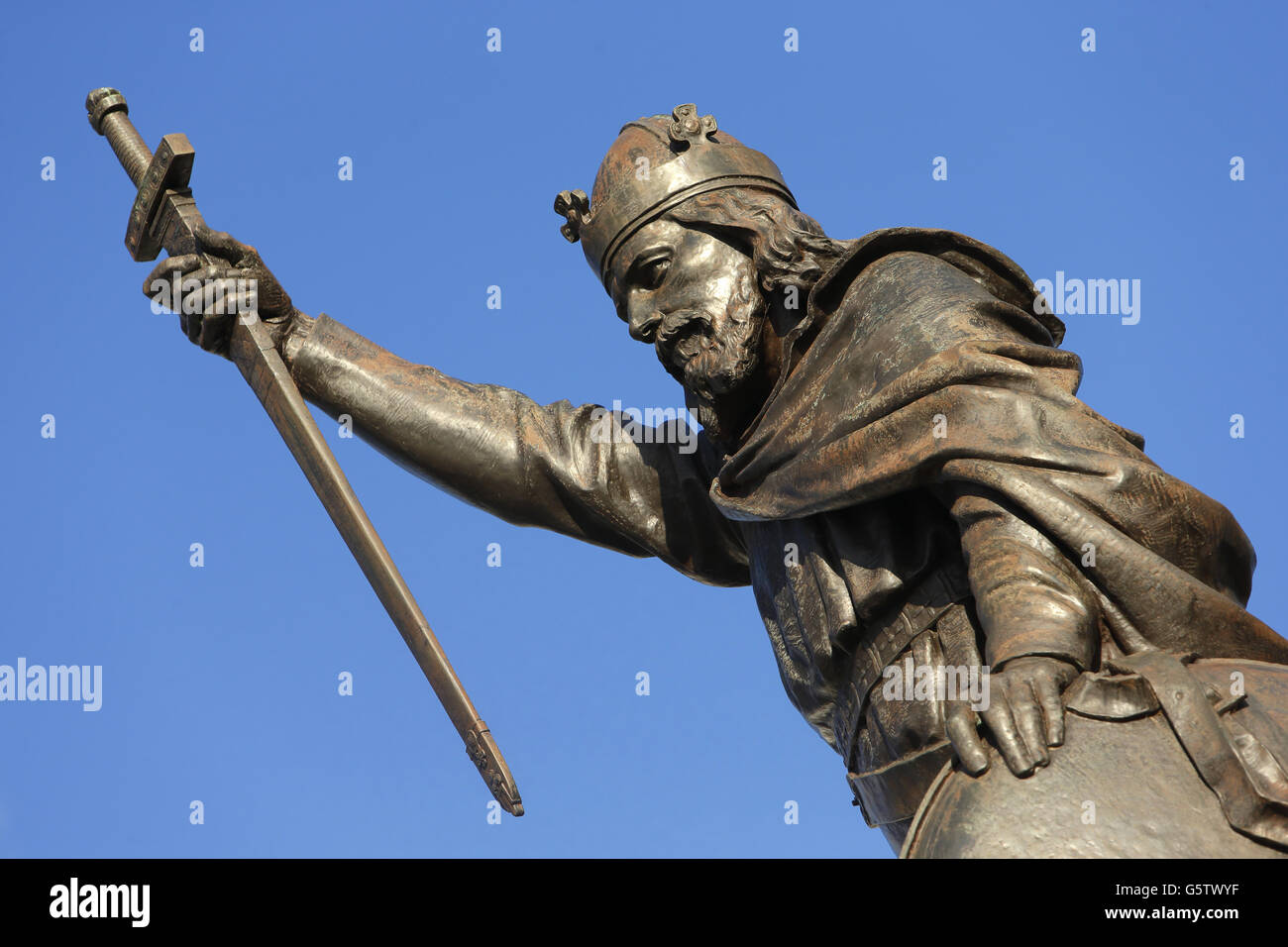 Una statua in bronzo di Re Alfred il Grande a Winchester High Street, nell'Hampshire. Gli archeologi dell'Università di Winchester hanno fatto una domanda per esumare e studiare le ossa che si ritiene giacciano in una tomba non marcata alla chiesa di San Bartolomeo a Winchester, per scoprire se sono il leggendario re sassone Alfred il Grande. Foto Stock