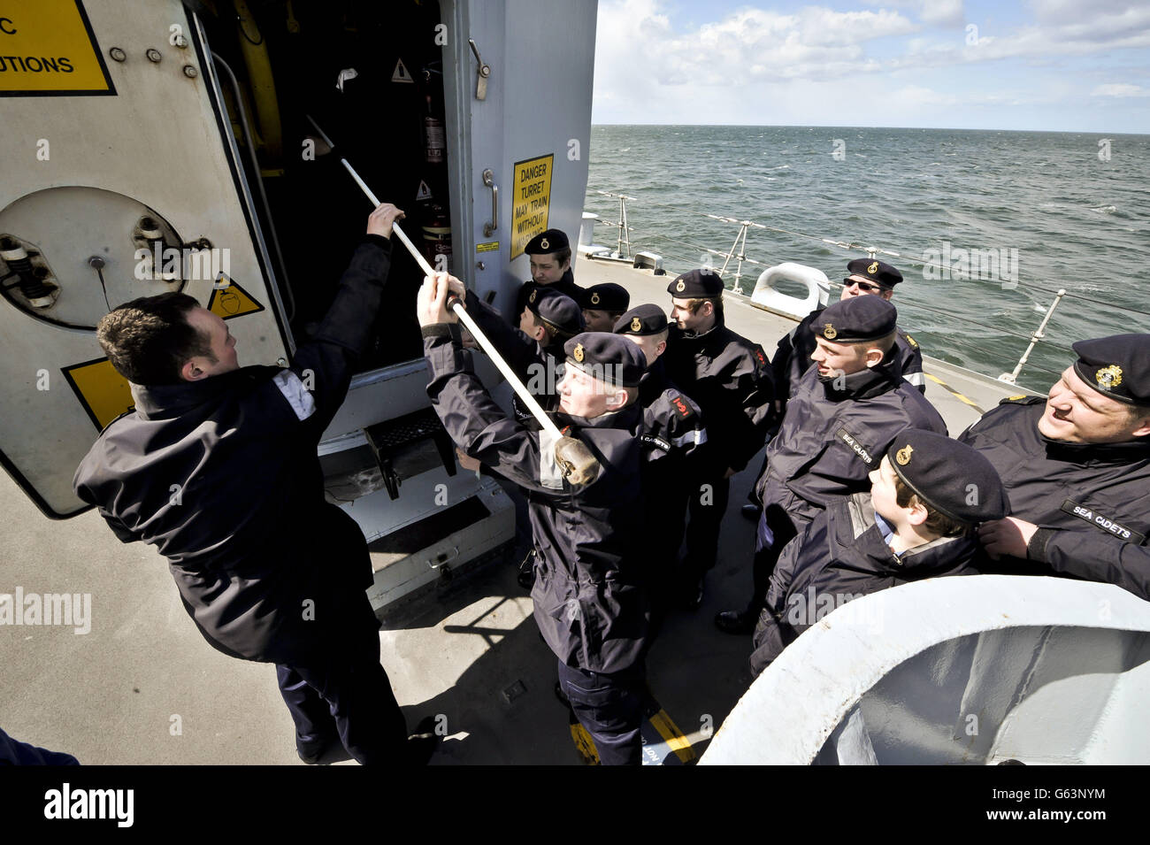 I cadetti marini del distretto di Edimburgo i cadetti marini puliscono il barile della pistola del 45 a bordo dell'HMS Edinburgh durante il tour del fiabesco della nave del Regno Unito in direzione di Leith Edinburgh, dove l'ultimo Destroyer della Royal Navy tipo 42 sta facendo la sua ultima visita a Edimburgo prima di essere smantellata. Foto Stock