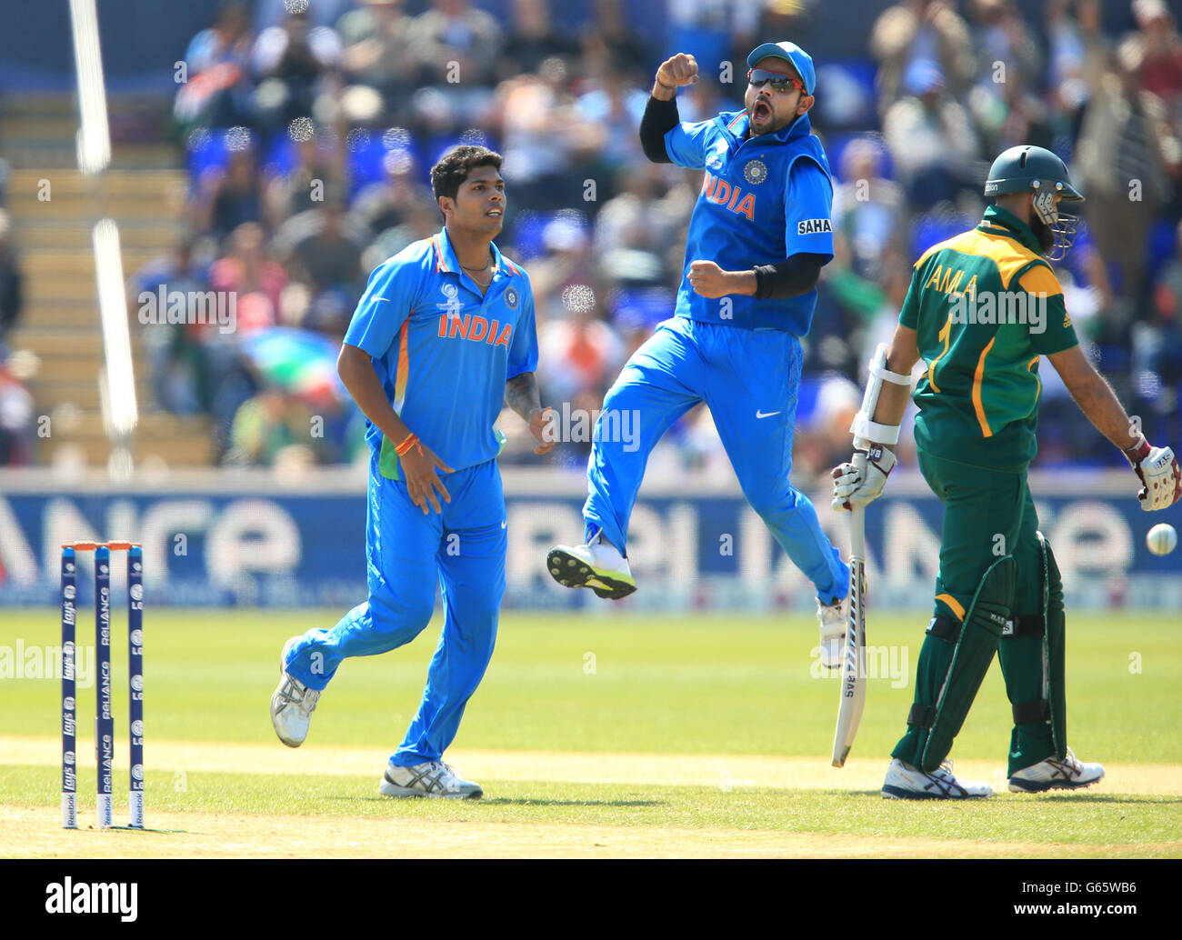 Cricket - Trofeo campioni ICC - Gruppo B - India / Sudafrica - SWALEC Stadium. Umesh Yadav dell'India celebra il cazzo di Hashim Amla del Sudafrica mentre Virat Kohli salta per la gioia Foto Stock