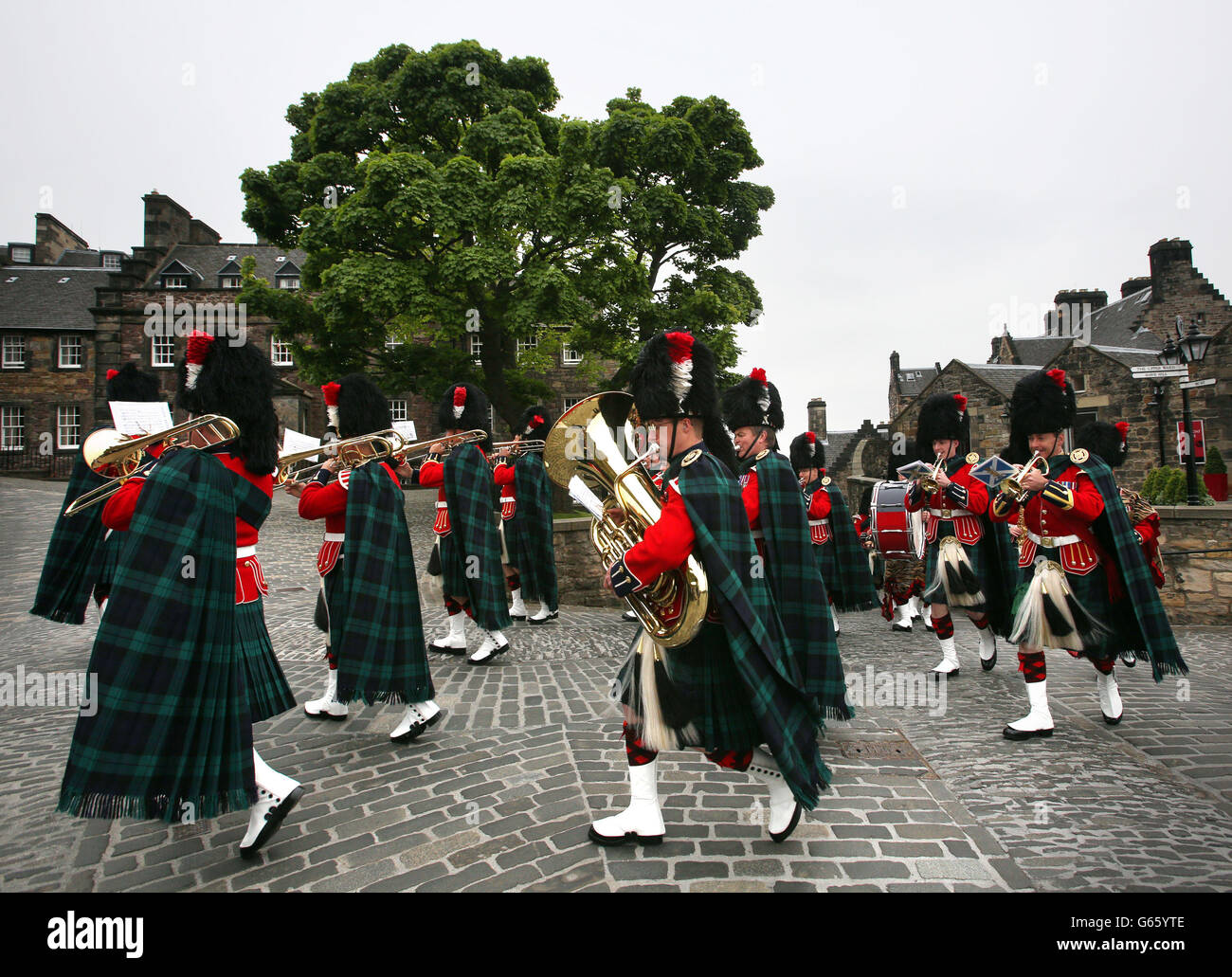 Una banda militare suona prima di un 21 - Gun Royal Salute è licenziato dal corpo di addestramento ufficiale delle università di Edimburgo dal castello di Edimburgo per celebrare il 92 compleanno del duca di Edimburgo. Foto Stock