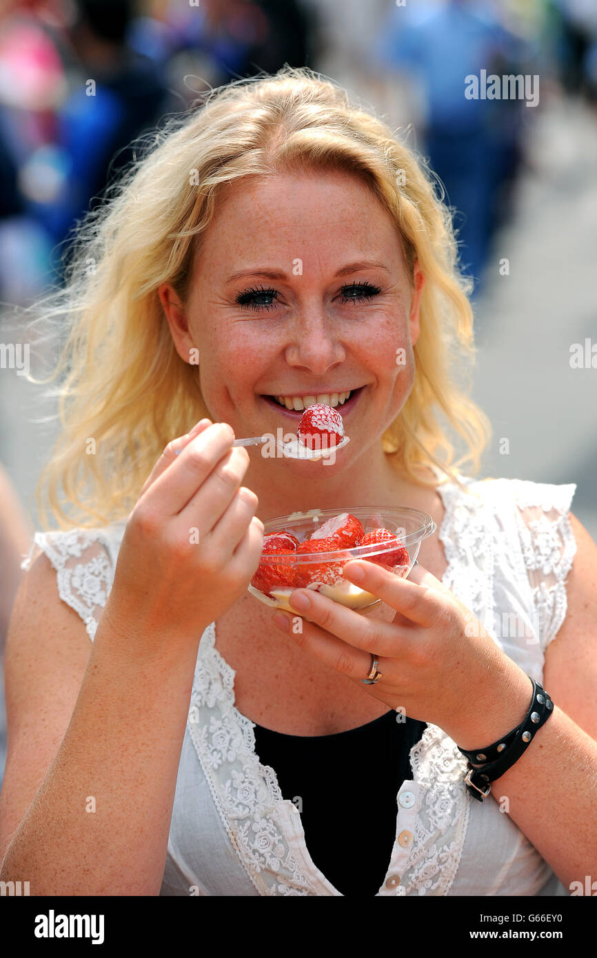 Tennis - Campionati di Wimbledon 2013 - giorno due - All England Lawn Tennis and Croquet Club. Uno spettatore mangia fragole e crema Foto Stock