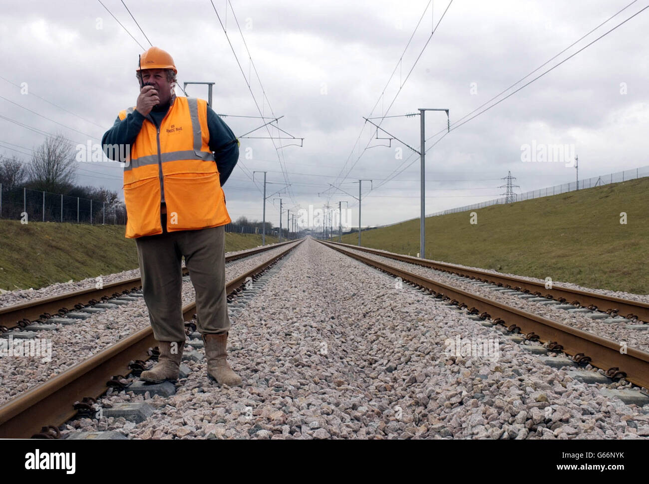 L'addetto alla sicurezza Cliff Jamieson cammina lungo il nuovo collegamento ferroviario del tunnel della Manica vicino al Viadotto Grange Alders nel Kent, mentre i tecnici effettuano i controlli finali sulle linee elettriche aeree a 25,000 volt sulle 46 miglia (74 km) della nuova ferrovia. *... tra Fawkham Junction, vicino Swanley, e il complesso del Tunnel della Manica a Cheriton. Una volta completato nel 2007, i 5.2 miliardi di CTRL dimezzeranno i tempi di viaggio dal centro di Londra al tunnel sotto la Manica. Presto i treni Eurostar inizieranno a testare la linea a velocità fino a 186 mph. Foto Stock